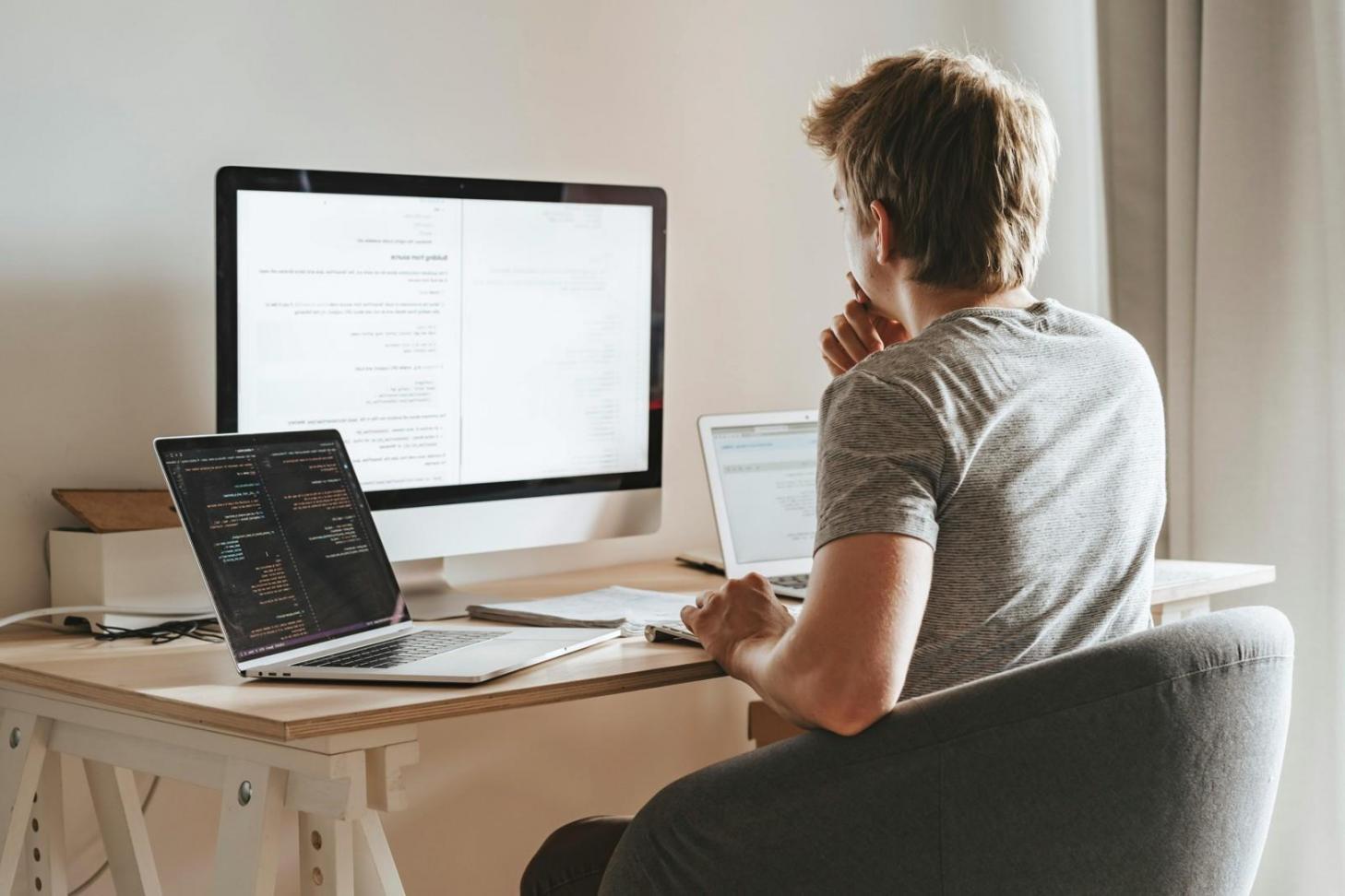 Mobile game development workspace showing screen designs and testing devices